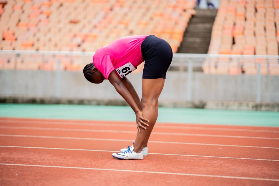 A woman athlete taking a break on a race track in Dar es Salaam, Tanzania.