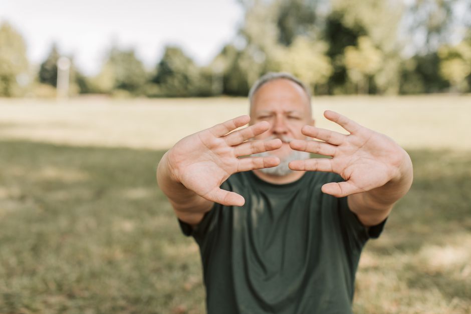 Elderly man enjoying a peaceful day outdoors, focusing on relaxation and mindfulness.